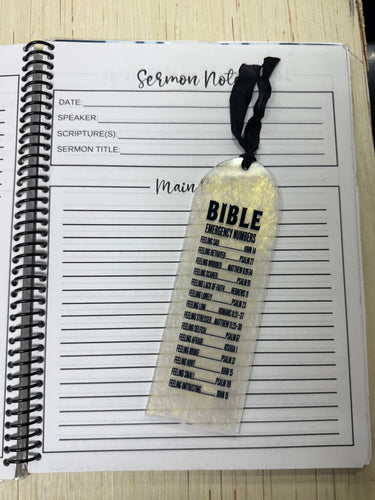 Notebook with a bookmark labeled 'Bible' on a wooden surface